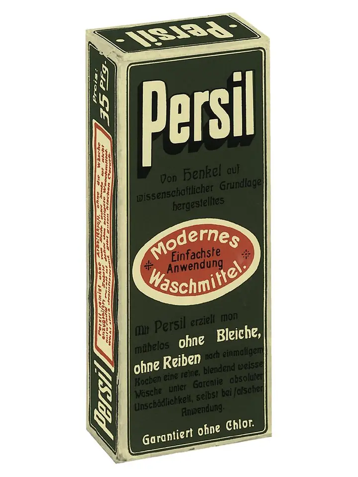 Caja vintage del detergente Persil con texto en alemán y etiqueta ovalada roja resaltando una aplicación moderna y sencilla.