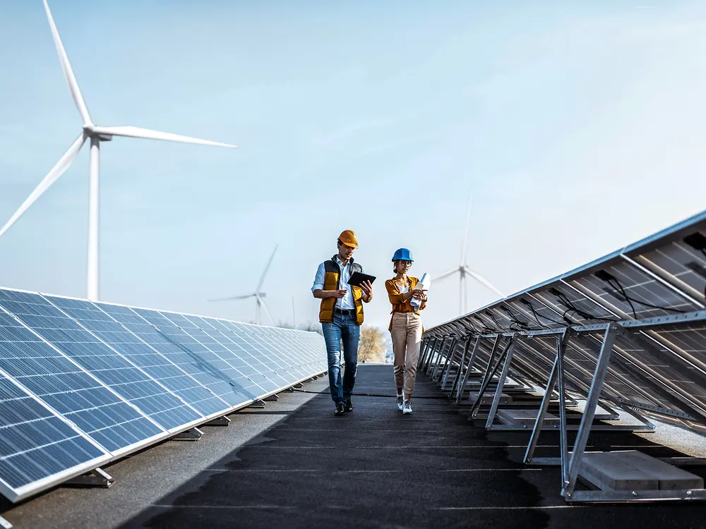 Dos hombres entre paneles solares.